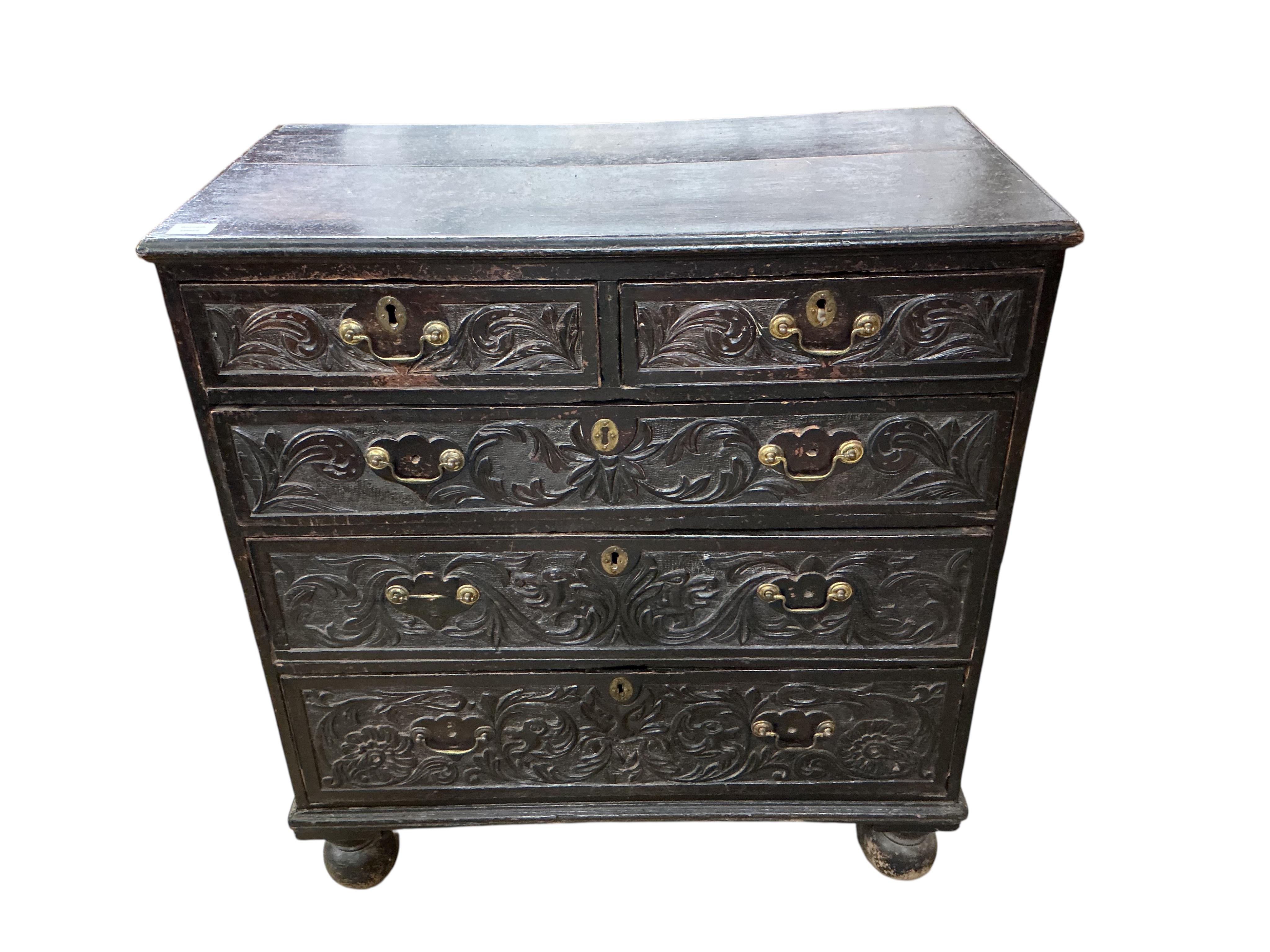 An 18th century oak chest, fitted with two short and three long drawers, later carved, width 89cm, depth 46cm, height 96cm